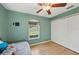 Bedroom with a daybed, ceiling fan and large window at 2551 Morrietta Ln, North Port, FL 34286