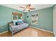 Charming bedroom with a daybed and light teal walls at 2551 Morrietta Ln, North Port, FL 34286