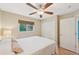 Bright bedroom featuring a ceiling fan and double door closet at 2551 Morrietta Ln, North Port, FL 34286