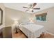 Spacious bedroom with ceiling fan, large window, and light flooring at 2551 Morrietta Ln, North Port, FL 34286