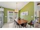 Dining area with a wood table and six leather chairs at 2551 Morrietta Ln, North Port, FL 34286