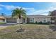 Single-story home with a palm tree and a screened-in porch at 2551 Morrietta Ln, North Port, FL 34286