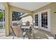 Screened patio with table and chairs, perfect for outdoor dining at 2551 Morrietta Ln, North Port, FL 34286