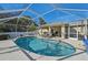 Inviting screened pool area with lounge chairs and lighting at 2551 Morrietta Ln, North Port, FL 34286