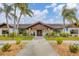 Country Village clubhouse featuring a walkway and palm trees at 2728 71St Street W Ct # 2078, Bradenton, FL 34209