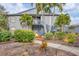 Gray condo building with stairs, landscaping, and palm trees at 2728 71St Street W Ct # 2078, Bradenton, FL 34209