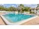 Community pool with brick deck and ample lounge chairs at 2728 71St Street W Ct # 2078, Bradenton, FL 34209