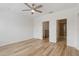 Bedroom with wood-look floors and ceiling fan, near bathroom at 284 Crew Ct, Sarasota, FL 34243