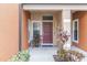 Townhome entry with a brown door and potted plants at 284 Crew Ct, Sarasota, FL 34243