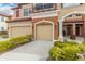 Two-story townhome with double garage and landscaped front at 284 Crew Ct, Sarasota, FL 34243