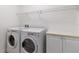 Convenient laundry room, with washer, dryer and shelving at 284 Crew Ct, Sarasota, FL 34243