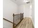 Upstairs hallway with wood-look flooring and railing at 284 Crew Ct, Sarasota, FL 34243