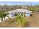 Aerial view of a well-maintained single-story home with lush, tropical landscaping at 2926 Sultan Ct, North Port, FL 34286