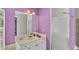 Bright bathroom with a walk-in shower, white cabinets, and calming purple walls at 2926 Sultan Ct, North Port, FL 34286