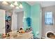 Bright bathroom featuring a vanity, updated lighting, and charming butterfly-themed decor at 2926 Sultan Ct, North Port, FL 34286