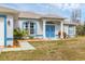 Inviting front entrance with a covered porch, double doors and manicured landscaping at 2926 Sultan Ct, North Port, FL 34286