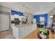 Modern kitchen with a granite island, white cabinets, stainless appliances, and a view into the dining area at 2926 Sultan Ct, North Port, FL 34286