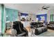 Open-concept living room showcasing an adjacent kitchen with modern appliances and colorful accent walls at 2926 Sultan Ct, North Port, FL 34286