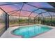 Screened-in pool offers a refreshing oasis with views of the surrounding natural landscape at 2926 Sultan Ct, North Port, FL 34286