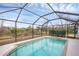 Screened pool with a tiled trim and clear blue water creates a beautiful, relaxing backyard oasis at 2926 Sultan Ct, North Port, FL 34286