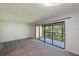 Living room with grey carpet and sliding doors to a balcony at 3011 Quail Holw # 3011, Sarasota, FL 34235