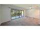 Living room with grey carpet and sliding doors to a balcony at 3011 Quail Holw # 3011, Sarasota, FL 34235