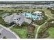 Aerial view of community pool, clubhouse, and homes at 3016 Formia Ct, Bradenton, FL 34211