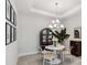 Bright dining room with round table, chandelier, and built-in hutch at 3016 Formia Ct, Bradenton, FL 34211