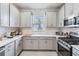 Modern kitchen with gray cabinets and stainless steel appliances at 3016 Formia Ct, Bradenton, FL 34211