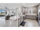 Open concept kitchen with gray cabinets and island overlooking living room at 3016 Formia Ct, Bradenton, FL 34211