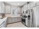 Modern kitchen with gray cabinets and stainless steel appliances at 3016 Formia Ct, Bradenton, FL 34211