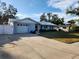 Single story home with attached garage and landscaped yard at 310 Parkland Ave, Sarasota, FL 34232