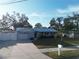 House with light blue exterior, metal roof, and driveway at 310 Parkland Ave, Sarasota, FL 34232