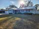 Ranch style home with light blue exterior and metal roof at 310 Parkland Ave, Sarasota, FL 34232