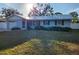 One-story home with light blue siding and metal roof at 310 Parkland Ave, Sarasota, FL 34232