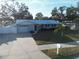 House with light blue exterior, metal roof, and landscaping at 310 Parkland Ave, Sarasota, FL 34232