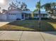 Light blue house with metal roof, white fence, and palm tree at 310 Parkland Ave, Sarasota, FL 34232