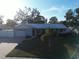 House with light blue exterior, metal roof, and driveway at 310 Parkland Ave, Sarasota, FL 34232