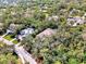 High-angle view of a house in a wooded neighborhood at 3142 Dick Wilson Dr, Sarasota, FL 34240