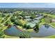 Aerial view of community with tennis courts, pool, and lush landscaping at 3142 Dick Wilson Dr, Sarasota, FL 34240