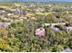 Aerial view showing home's location in a lush, wooded neighborhood near a golf course at 3142 Dick Wilson Dr, Sarasota, FL 34240