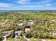 Aerial view of the house nestled in a wooded area, surrounded by other homes at 3142 Dick Wilson Dr, Sarasota, FL 34240