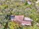 Aerial view of the house and private pool surrounded by lush trees at 3142 Dick Wilson Dr, Sarasota, FL 34240