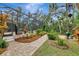 Pathway to the pool and patio area, surrounded by lush landscaping at 3142 Dick Wilson Dr, Sarasota, FL 34240