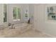 Spa-like bathroom with a large soaking tub and plenty of natural light at 3142 Dick Wilson Dr, Sarasota, FL 34240