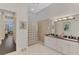 Bathroom with double vanity, glass block shower, and elegant decor at 3142 Dick Wilson Dr, Sarasota, FL 34240