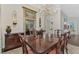 Spacious dining room with large chandelier and hardwood floors at 3142 Dick Wilson Dr, Sarasota, FL 34240