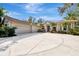 Three-car garage, circular driveway, and manicured landscaping at 3142 Dick Wilson Dr, Sarasota, FL 34240