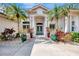 Inviting home entrance with lush landscaping and teal doors at 3142 Dick Wilson Dr, Sarasota, FL 34240