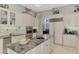 Island kitchen with granite countertops and stainless steel appliances at 3142 Dick Wilson Dr, Sarasota, FL 34240